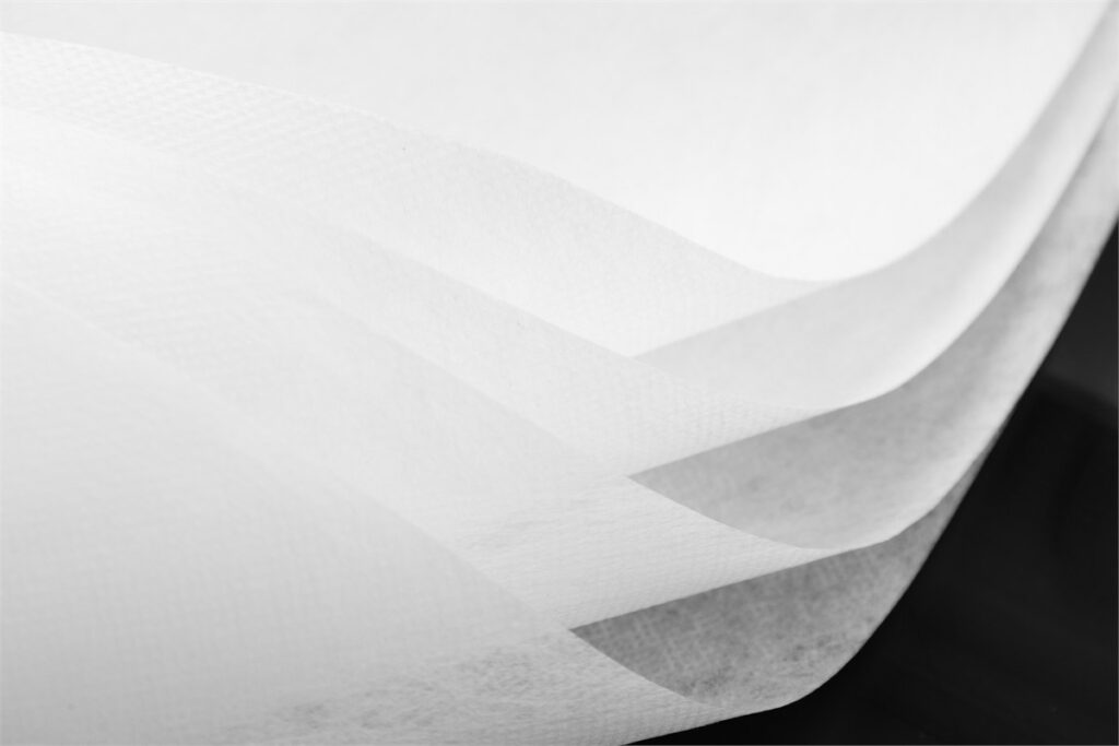 Non-woven PET spunbond fabric with smooth layered texture, high strength and durability